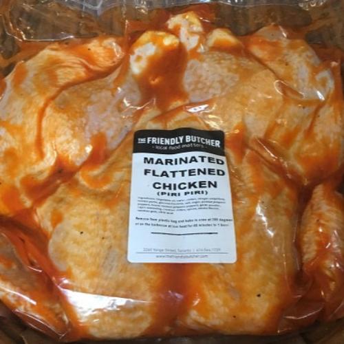 Sealed bag of marinated flattened chicken, piri piri